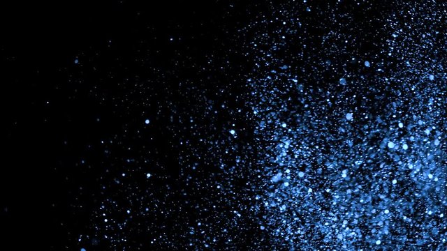 Glitter background in super slow motion shooted with high speed cinema camera at 1000fps 4K. BLUE GLITTER. Golden glitter sand or dust .
