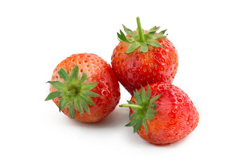 Two strawberries close up on white background.