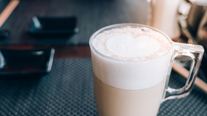 Coffee cup on cafe wood table banner panorama background, outdoor meeting