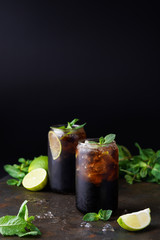 Cuba Libre or long island iced tea cocktail with strong drinks, cola, lime and ice in glass, cold...