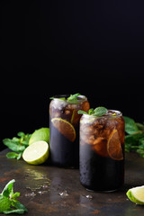Cuba Libre or long island iced tea cocktail with strong drinks, cola, lime and ice in glass, cold longdrink or lemonade