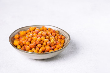 Organic sea buckthorn berries in a bowl