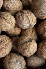Walnuts in shell .Inshell walnuts close-up. Brown walnuts.