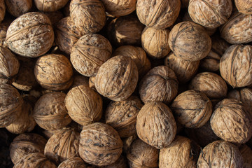 Walnuts in shell .Inshell walnuts close-up. Brown walnuts.
