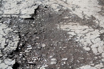 Asphalt texture with a pit