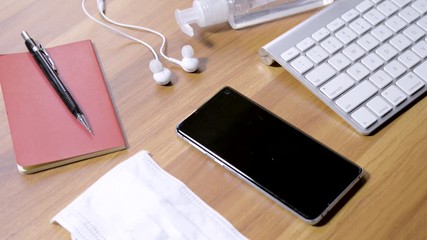 Disinfecting cell phone with cloth and alcohol, avoiding coronavirus