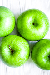 ripe green apples white table background