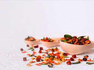 Super Food. Berry fruit drink In a wooden spoon on a white background. . Recovery after illness, virus. Immunity strengthening. Lingonberry, sea buckthorn, cranberry, lingonberry leaf, carrot, pineapp