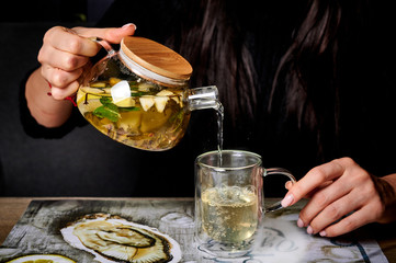 a visitor of a restaurant drinks green tea