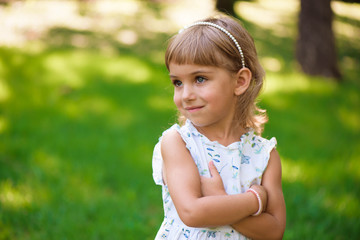 Beautiful little young girl outdoorin a park.