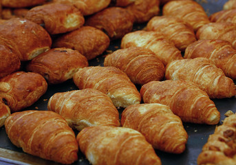 Close up fresh baked croissants on retail display
