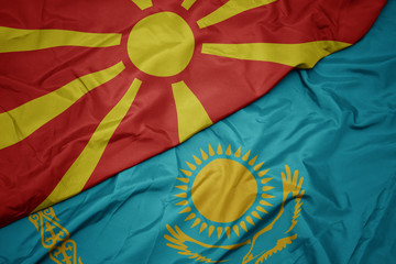 waving colorful flag of kazakhstan and national flag of macedonia.