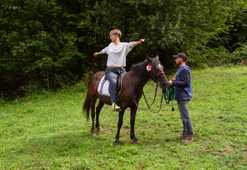 man and woman go horse riding