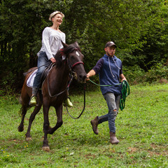 man and woman go horse riding