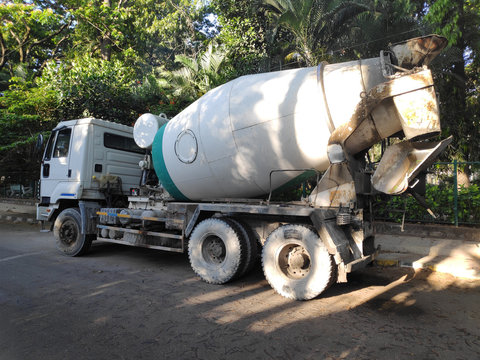 A cement truck parked along a road