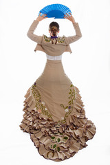 flamenco dancer with her brown bata de cola and her blue fan