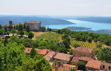 chateau and church in Aiguines and St Croix Lake at background, France