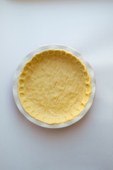 cooking tuna and spinach pie. raw tuna and spinach pie ingredients. Dough. grated cheese. Homemade tuna pie with cheese. Top view.