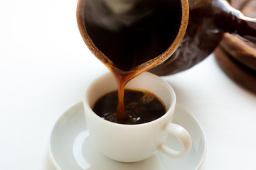 homemade coffee in turk. Homemade tradtional coffee at home. Morning with coffee. from Turks pour coffee into a cup.