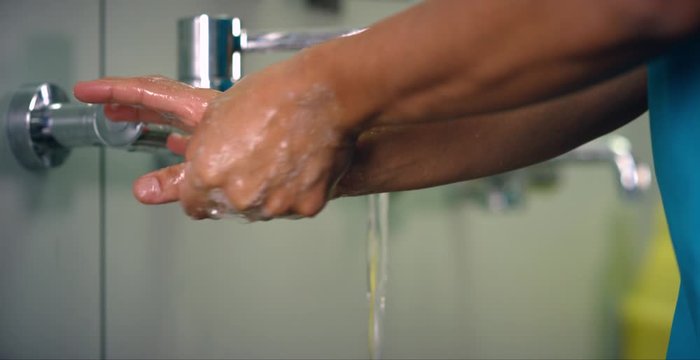 Female Medical Worker Washes Hands