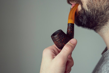 man holding his pipe