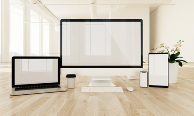 responsive devices on the floor with white screen,