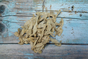 pickled fish is made by drying and meddling with salt on a wooden background