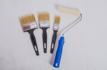 A set of brushes and a roller for painting walls for repairs in an apartment, a house. Preparation...