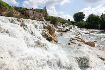 Gorello, Saturnia, Grosseto, Tuscany, Italy - May 29 2018: tourists swimming and relaxing in...