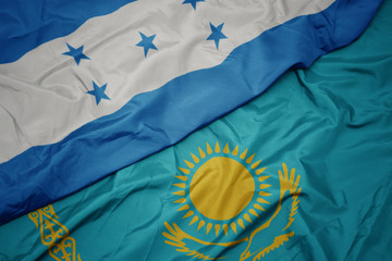 waving colorful flag of kazakhstan and national flag of honduras.