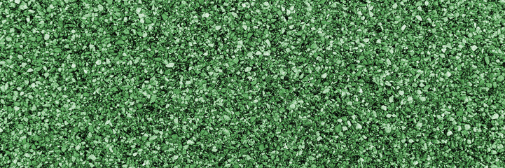 Closeup green bitumen shingle. Rough background made of roofing material