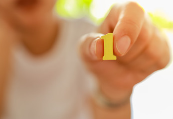Business and Target Concept. Close up of business woman holding yellow wooden number 1