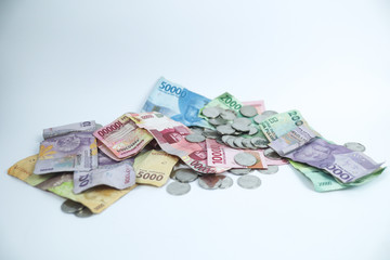 Heaps of Rupiah on a white table. Indonesian currency with a white background