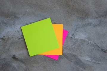 Colorful sticky notes on stone background Image