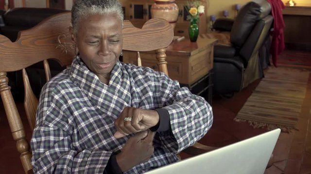 Front View Of A Older Black Woman Discussing Her Wrist Pain During A Video Chat