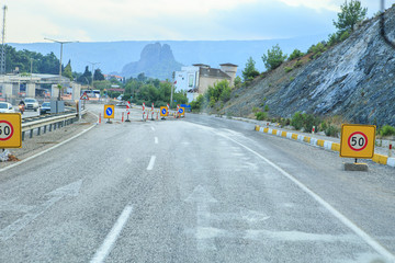 Signs and fences on the highway in front of the repair site