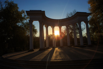 Colonade silhouette in the park at sunset or sunrise