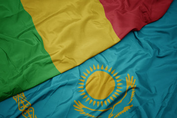 waving colorful flag of kazakhstan and national flag of mali.