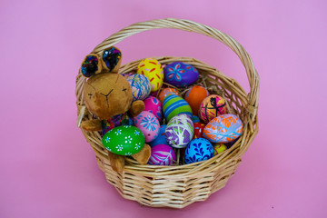 The colorful Easter eggs in the basker pink background