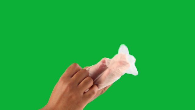 male hand on green chromakey put on a latex glove to protect one click keying
