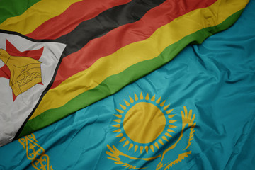 waving colorful flag of kazakhstan and national flag of zimbabwe.