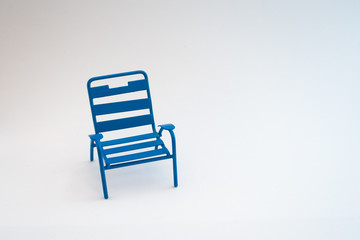 Closeup of an isolated blue chair on a white background