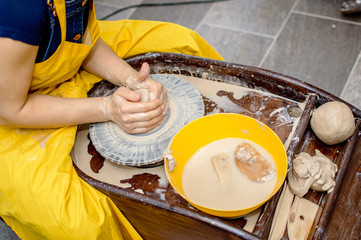 the girl works on a Potter 's wheel