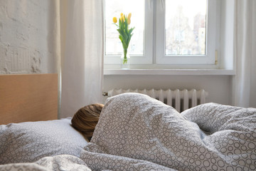 Woman sleep in bed. Blond hair girl under blanket on pillow. Wake up. Dreaming. Happy morning in...