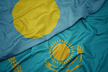 waving colorful flag of kazakhstan and national flag of .