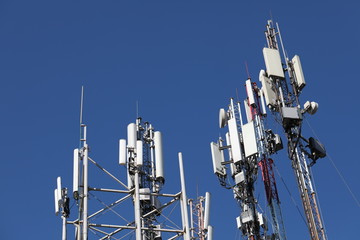 Mobile towers on blue sky background. Many communication equipment.