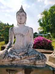 White stone Buddha statue and blue sky background at Wat Yai Chaya Mongol in Ayutthaya, Thailand.  Beautiful Buddha statue in Asia.