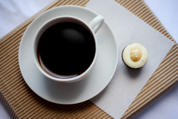 
cup of coffee with handmade sweets on eco background