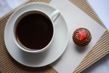 
cup of coffee with handmade sweets on eco background