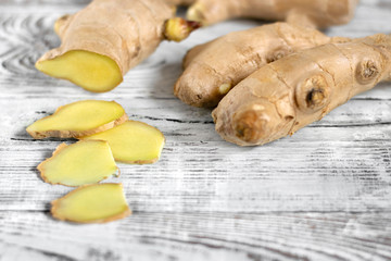 Fresh ginger root on the white wooden table. Copy space